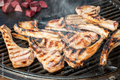 Lamb cutlets chops grilling on barbecue plate . Backyard BBQ grill cooking. Australia Day celebration