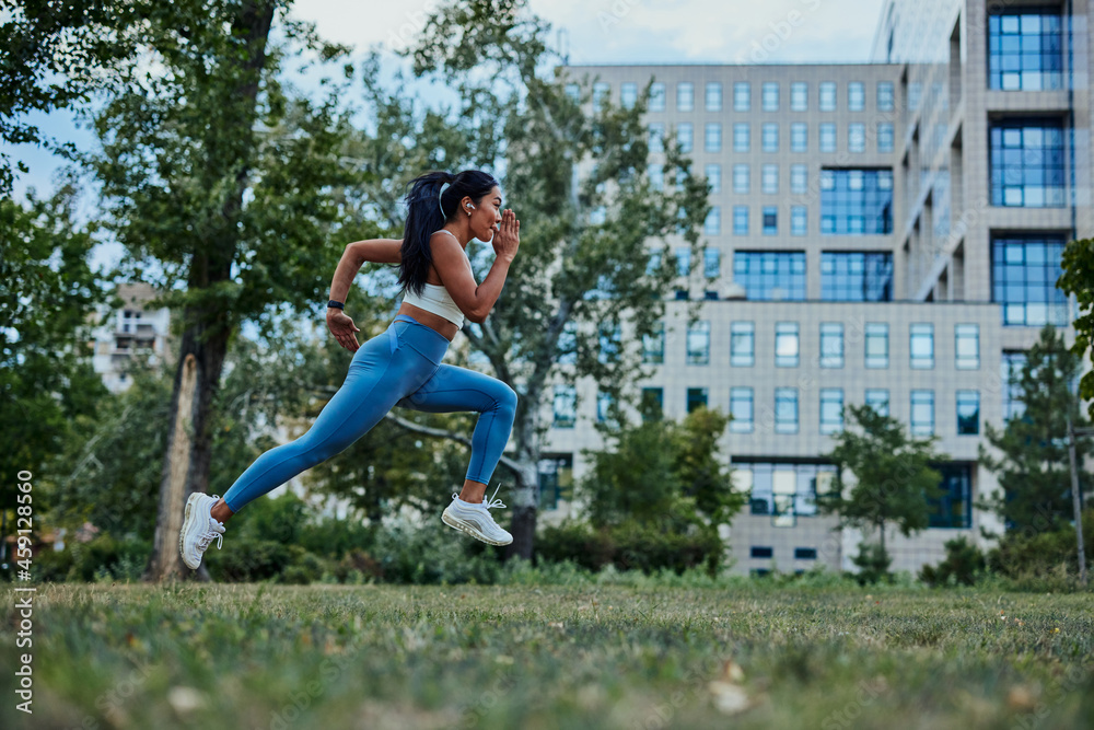 Fototapeta premium Asian woman running in park to achieve her personal best