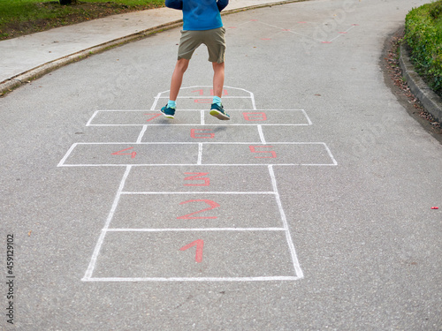 8 year old boy playing hopscotch