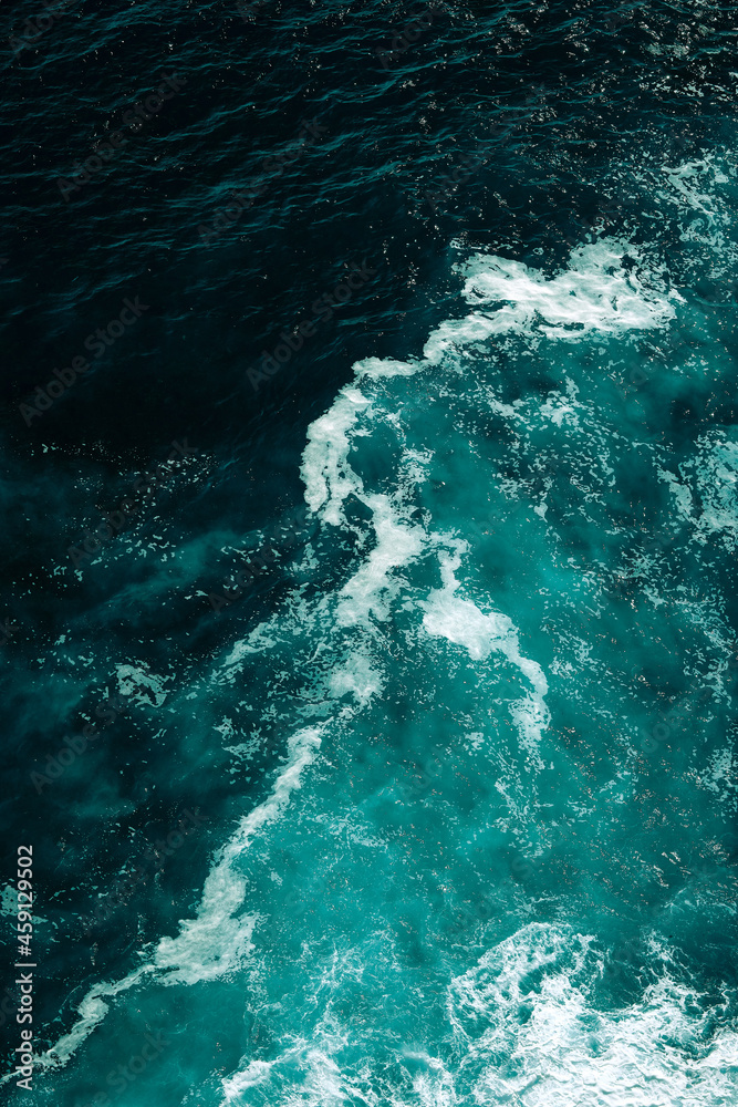 Aerial view to seething waves with foam. Waves of the sea meet each other during high tide and low tide