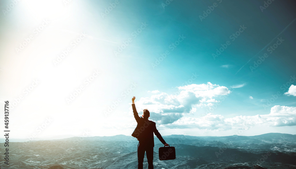 Silhouette of successful businessman keeping hands up hiking on the top of mountain - Celebrating success, winner and leader concept	
 - obrazy, fototapety, plakaty 