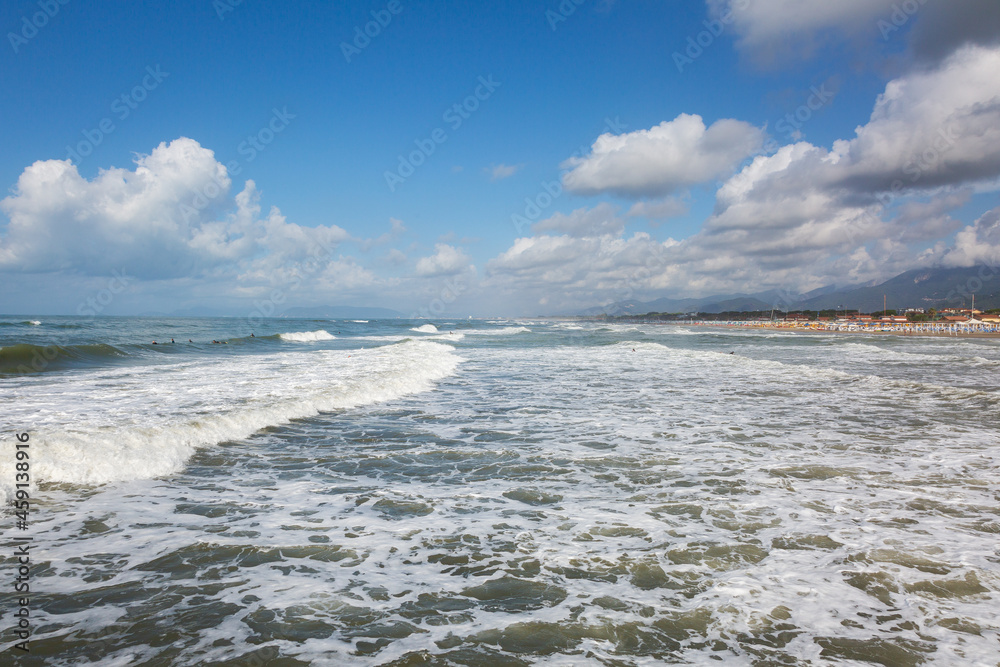 Fototapeta premium Forte dei Marmi, Lucca, Tuscania, Italy. Sea with surfers