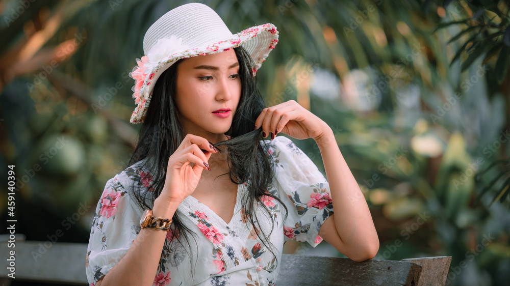 Beautiful young asian women in retro flowers pink dresses styles and hat vintage