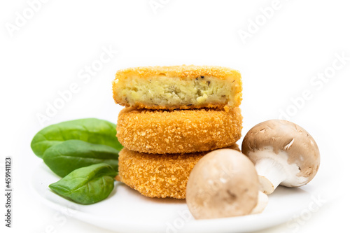 Potato cutlets with mushrooms on a white plate.