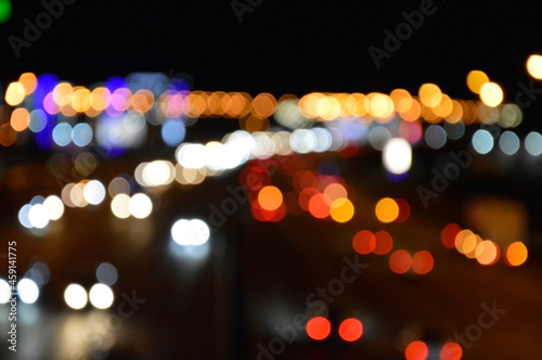 blurred lights of the night city red blue yellow on a black background festive mood bright abstraction background on the desktop © Вадим Шаповал