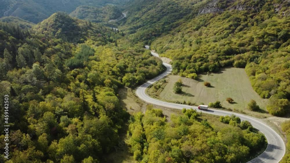 The truck is going on the winding road aerial view The truck is going on the winding road aerial view