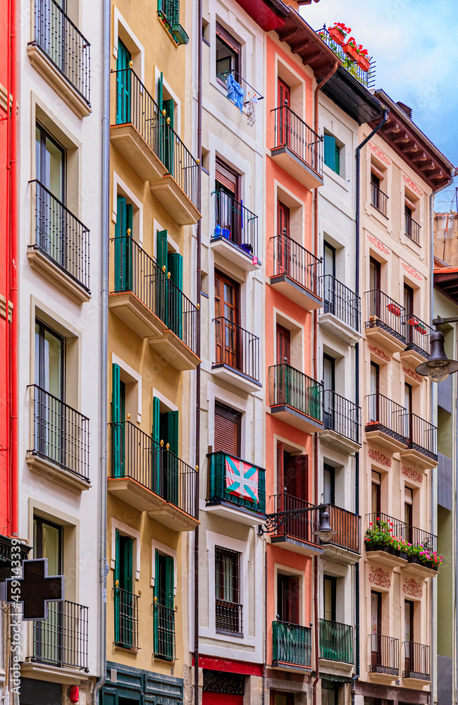 Colorful house facades and ornate metal balconies with flowers in the old town or Casco Viejo in Pamplona, Spain famous for running of the bulls