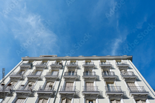 Corners of classical facade with elegant metallic balconies and shutters downtown Madrid, Spain