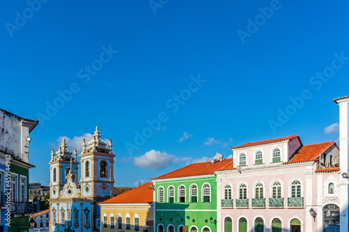 Facades of colorful houses and tower of an old baroque church in Pelourinho  the famous historic center of Salvador  Bahia