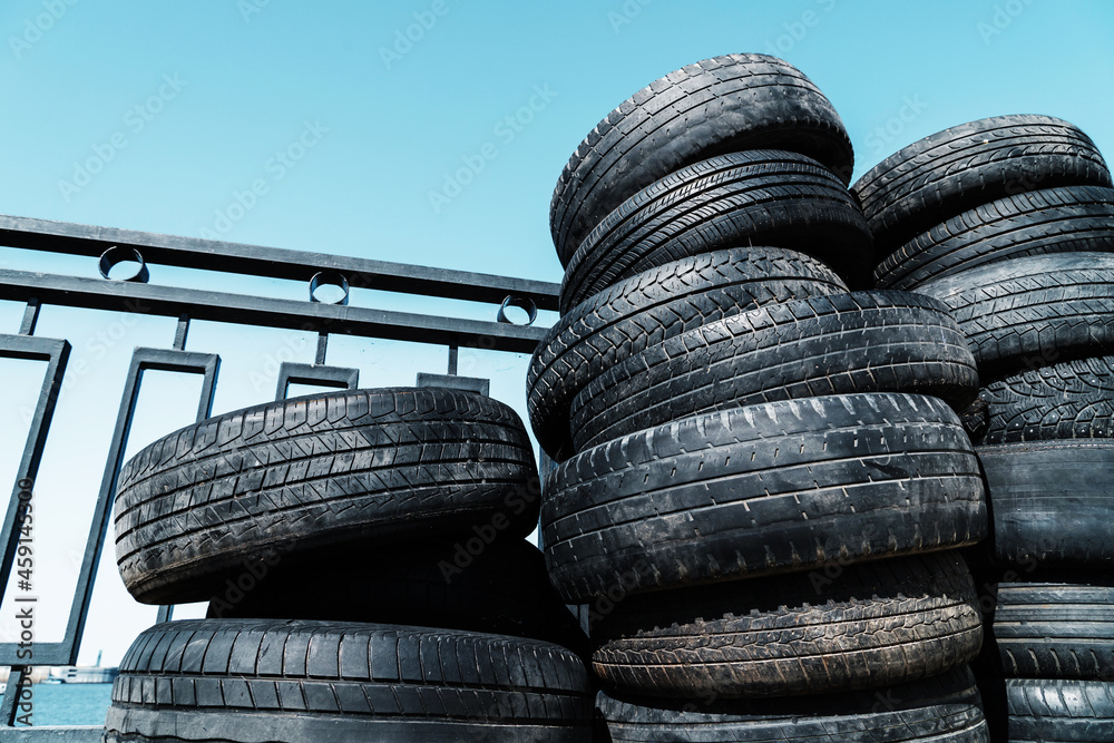 Warehouse of used car tires in the open air. Close-up Warehouse of used car tires in the open air. Close-up
