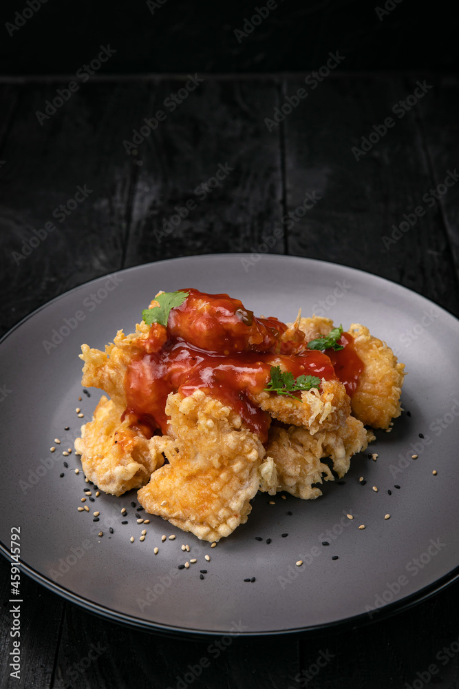grilled chicken fillet with sauce on a dark background
grilled chicken fillet with sauce on a dark background