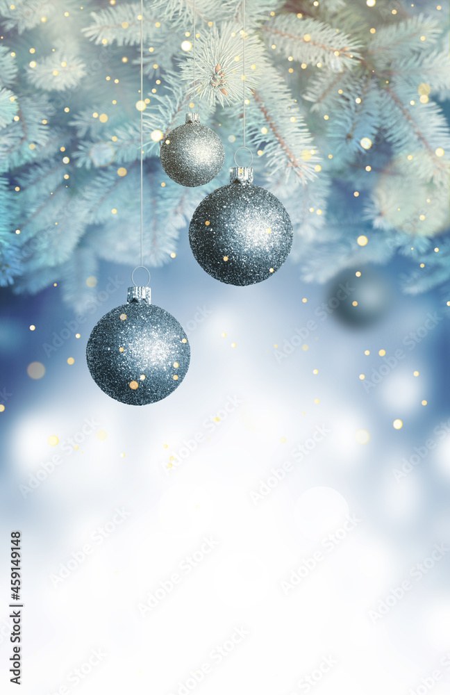 Christmas balls on a blue Christmas tree branch over blurred shiny background. Space for text Christmas balls on a blue Christmas tree branch over blurred shiny background. Space for text