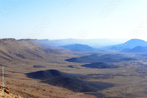 Mountain landscape  desert. Makhtesh Ramon Crater in Negev desert  Israel. Stony desert panoramic view. Unique relief geological erosion land form. National park Makhtesh Ramon or Ramon Crater