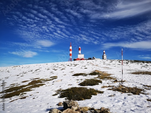Antenna lighthouse shape construction at the top of the snowy mountain in Madrid Navacerrada Bola del Mundo