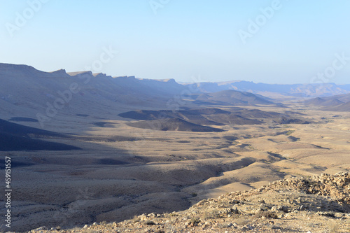 Mountain landscape  desert. Makhtesh Ramon Crater in Negev desert  Israel. Stony desert panoramic view. Unique relief geological erosion land form. National park Makhtesh Ramon or Ramon Crater