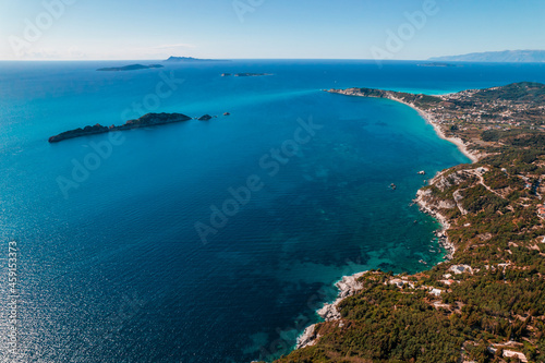 Aerial drone view to seascape with clear blue water. Amazing azure Mediterranean coast background. Travel destination, universal nature, resort, summer vacation. 