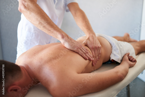 Closeup of man massaging a back, massage cabinet, healthy lifestyle