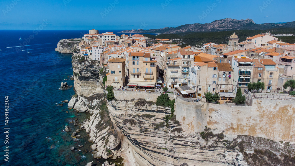 Aerial view of old houses built on the edge of the cliffs of Bonifacio overlooking the Mediterranean Sea in the south of the island of Corsica, France