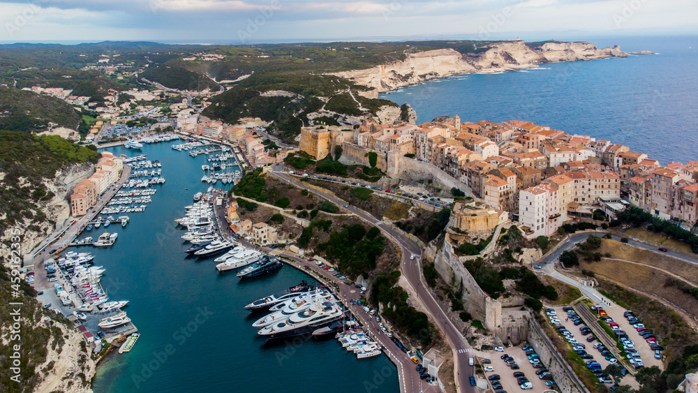 Aerial view of the marina and cape of Bonifacio in the south of the island of Corsica in France - Medieval citadel built on a rocky promontory overlooking the Mediterranean Sea