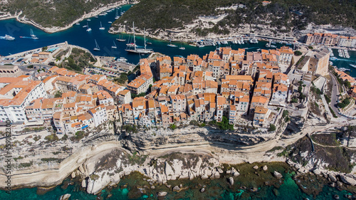Aerial view of the old city center of Bonifacio, built on a cape in the south of the island of Corsica in France - Old houses built on the edge of limestone cliffs overlooking the Mediterranean Sea