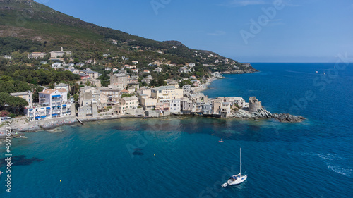 Fototapeta Naklejka Na Ścianę i Meble -  Aerial view of Erbalunga, a small fishing village on the Corsican Cape, France - Ruins of a Genoese Tower at the tip of a rocky cape in the Mediterranean Sea