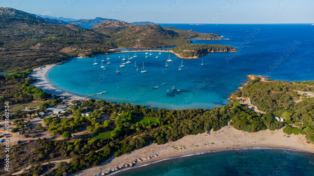 Aerial view of the bay of Rondinara in the South of Corsica, France - Sandy beach in the shape of a seashell with turquoise waters in the Mediterranean Sea