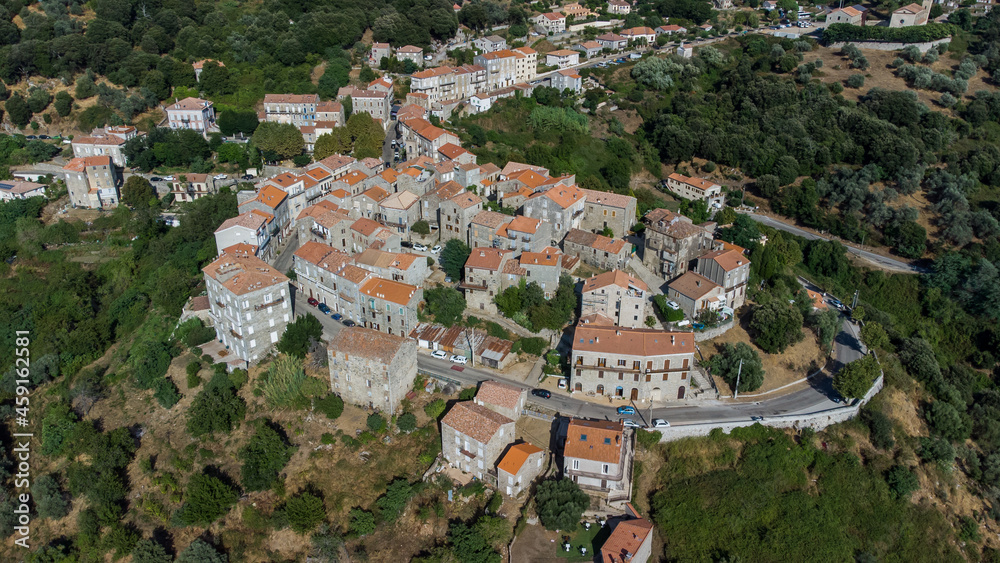 Aerial view of the village of Sainte Lucie de Tallano in the mountains of Southern Corsica, France - Round shaped medieval village with old houses surrounded by pine forests