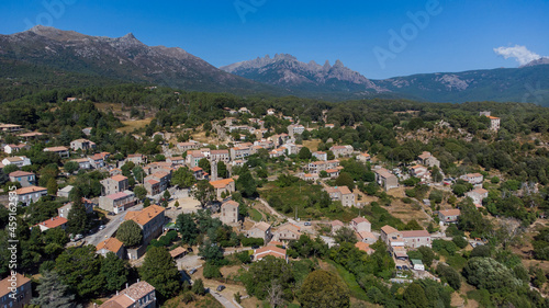 Aerial view of the mountainous village of Quenza in the Alta Rocca region of the South of Corsica, France - Stone buildings in front of the famous Bavella Peaks © Alexandre ROSA