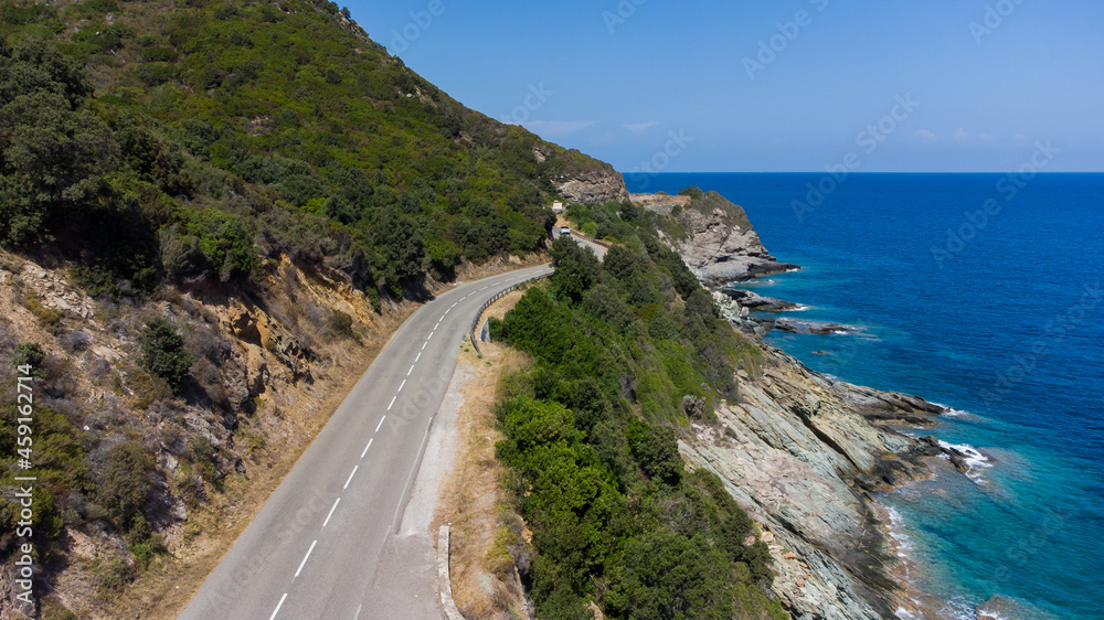 Aerial view of the ruins of the round Genoese tower of l'Osse on the Cap Corse, Corsica, France - Remains of a medieval lookout in the curve of a road overlooking the Mediterranean Sea Aerial view of the ruins of the round Genoese tower of l'Osse on the Cap Corse, Corsica, France - Remains of a medieval lookout in the curve of a road overlooking the Mediterranean Sea