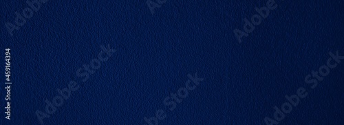 Elegant navy blue background with simple design and copy space.  Bluish abstract textured material, dark color wallpaper for wide banner, header, website template, etc.
