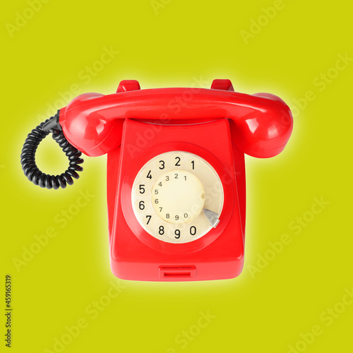 Top view Red vintage phone on a yellow background