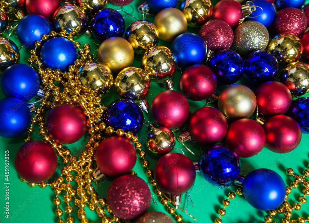 colored Christmas tree toys and beads are scattered on the table colored Christmas tree toys and beads are scattered on the table