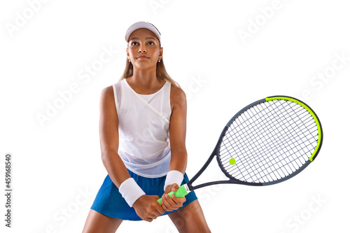Tennis player isolated on white background. Beautiful girl teenager and athlete with racket in white sporswear and hat on tennis court. Fashion and sport concept. © Mike Orlov