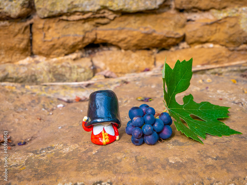 Beefeater British Royal Guard near a grape and leaf in the garden
