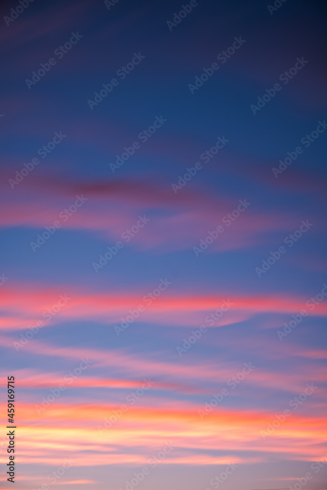 Clouds in the evening sky turn colors as the sun sets Clouds in the evening sky turn colors as the sun sets