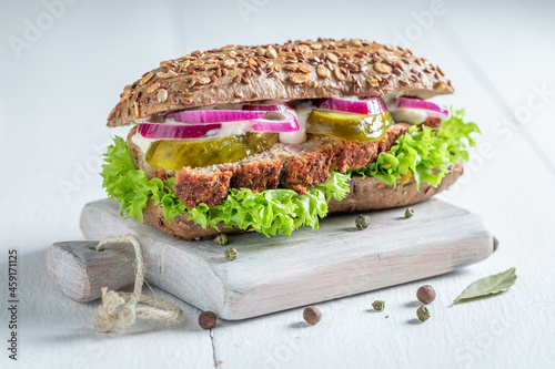 Savory pate sandwich with pickled cucumbers and lettuce for breakfast.