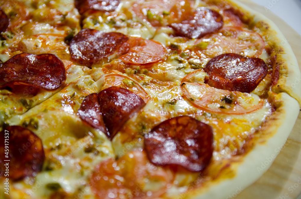 pizza with salami and cheese close up in a contrasting light pizza with salami and cheese close up in a contrasting light