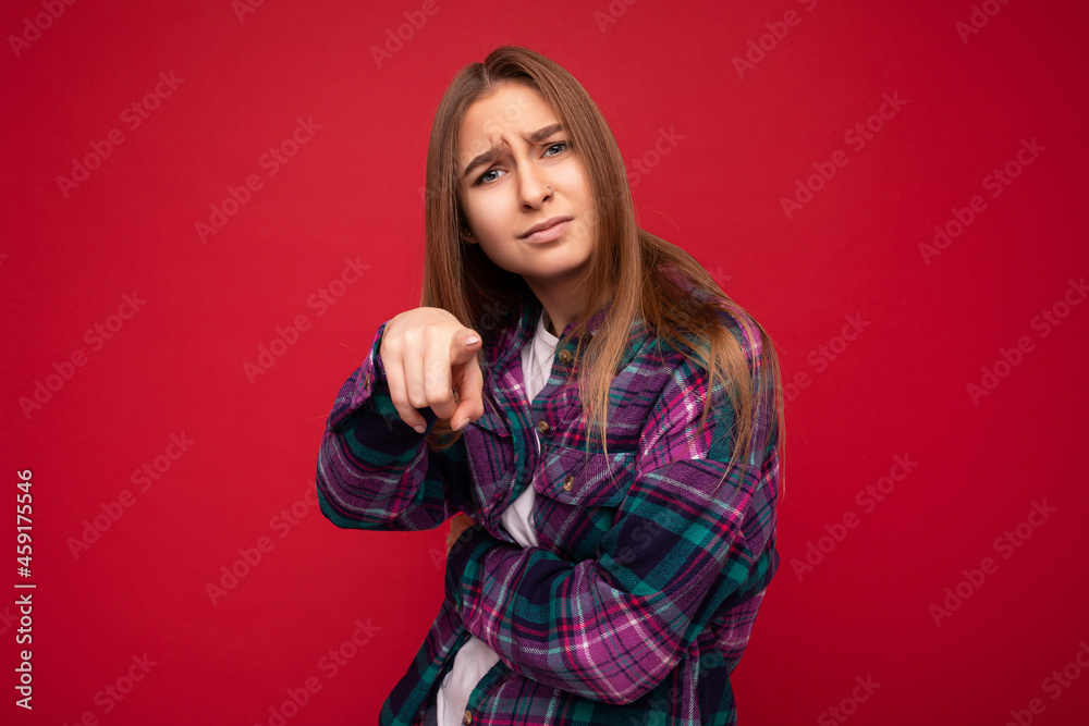 Photo of sad upset offended touchy moody young charming nice pretty dark blonde woman wearing hipster purple check shirt isolated over red background with free space and pointing finger at camera Photo of sad upset offended touchy moody young charming nice pretty dark blonde woman wearing hipster purple check shirt isolated over red background with free space and pointing finger at camera