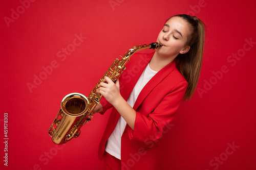 Canvas Print Photo shot of pretty happy brunette little female teenager wearing stylish red j