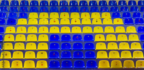 Yellow and blue stadium empty chairs stands quarantine
