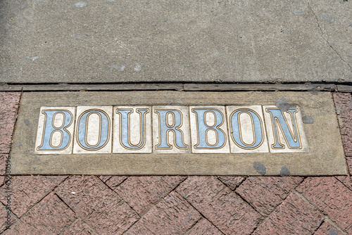Traditional Bourbon Street Tile Inlay on Sidewalk in French Quarter in New Orleans, Louisiana, USA