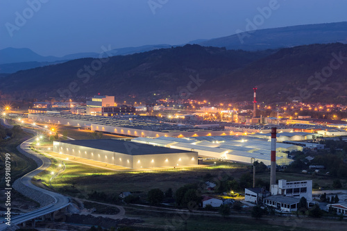 Illuminated modern factory and old, ruined factory night view from above
