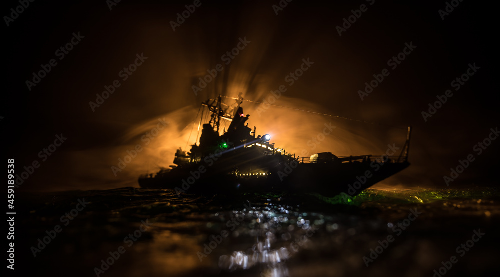 Fototapeta premium Silhouettes of a crowd standing at blurred military war ship on foggy background. Selective focus.