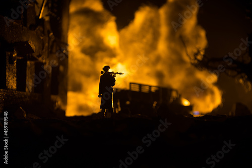 Military soldier silhouette with bazooka. War Concept. Military silhouettes fighting scene on war fog sky background, Soldier Silhouette aiming to the target at night.