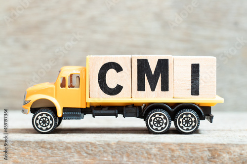 Toy truck hold alphabet letter block in word CMI (Abbreviation of Cost management index, Co-managed inventory,Customer Managed Inventory or case mix index) on wood background