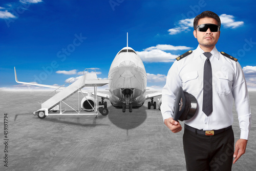 Pilot airplane in front of movable boarding ramp near the entrance to the passenger airplane