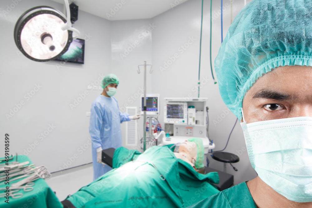closed up image of surgeon with team and equipment tools for surgeons arranged on a table in operating room closed up image of surgeon with team and equipment tools for surgeons arranged on a table in operating room