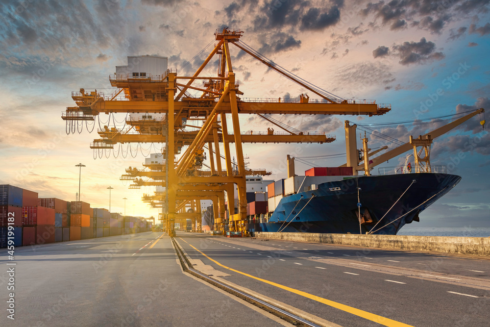 Container loading in a cargo freight ship with crane to shore lift up loading during cargo operation in sunrise time import and export  logistic and transportation concept.