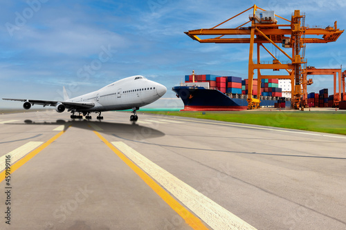 Airplane on the runway and container cargo ship with commercial delivery cargo being unloaded with at the harbor and airport