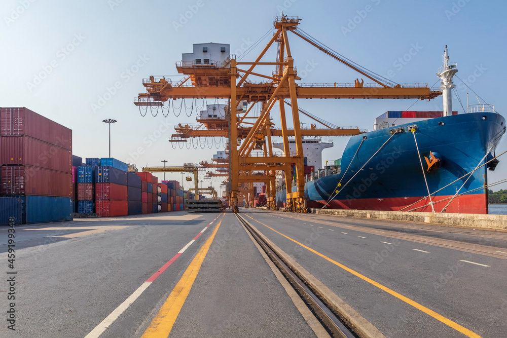 Container loading in a cargo freight ship with crane to shore lift up loading export containers box in import and export business logistic industry and transportation concept.